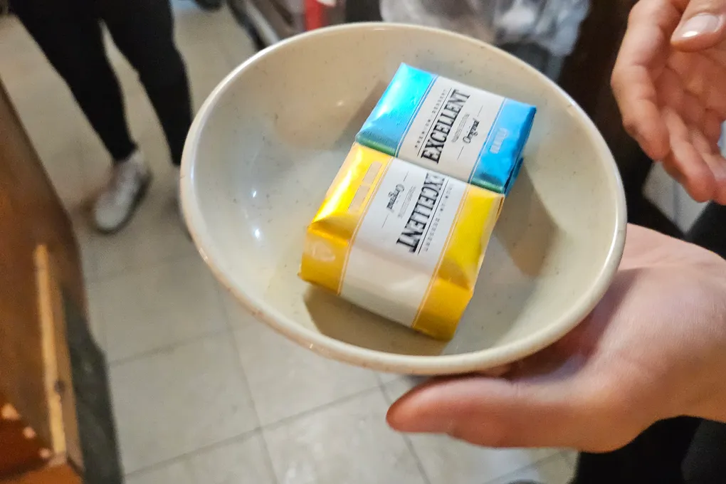 A small bowl holding two sticks of gum offered to guests after their meal at Baeksong