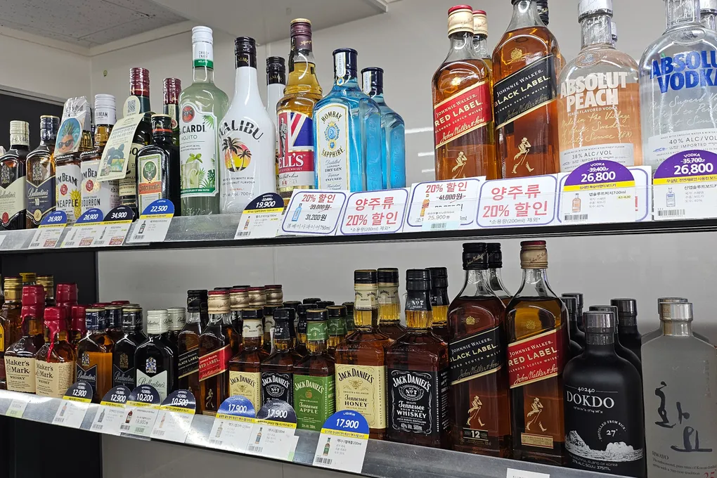 Shelves of whisky and spirits including Johnnie Walker and Absolut at a Korean convenience store