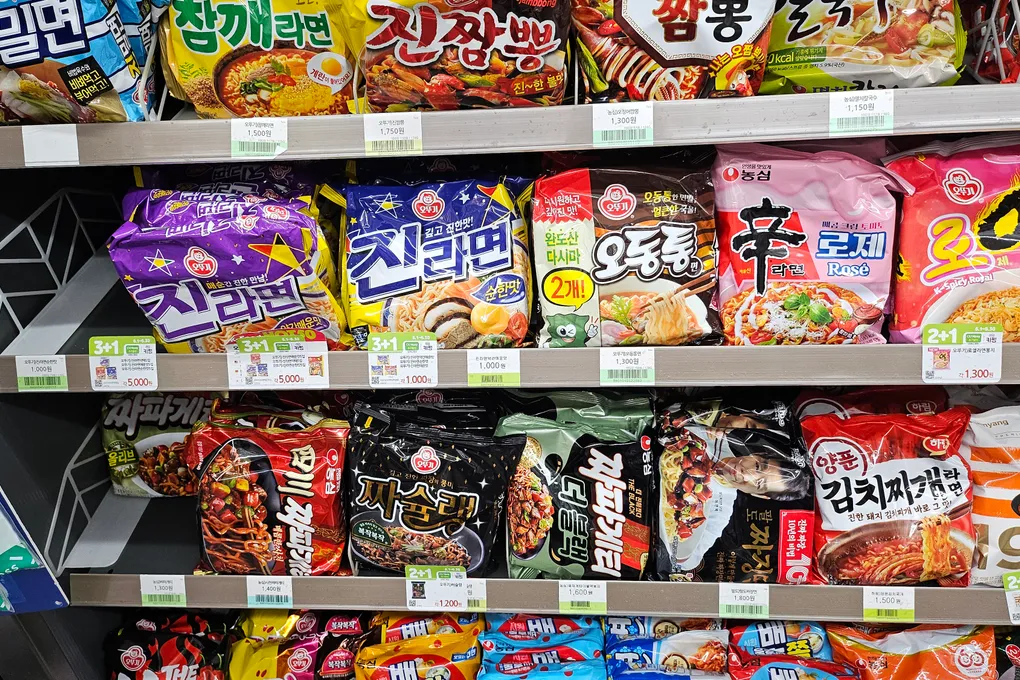 Packet instant noodles at a Korean convenience store including Jin Ramen, Shin Ramyun, and Buldak