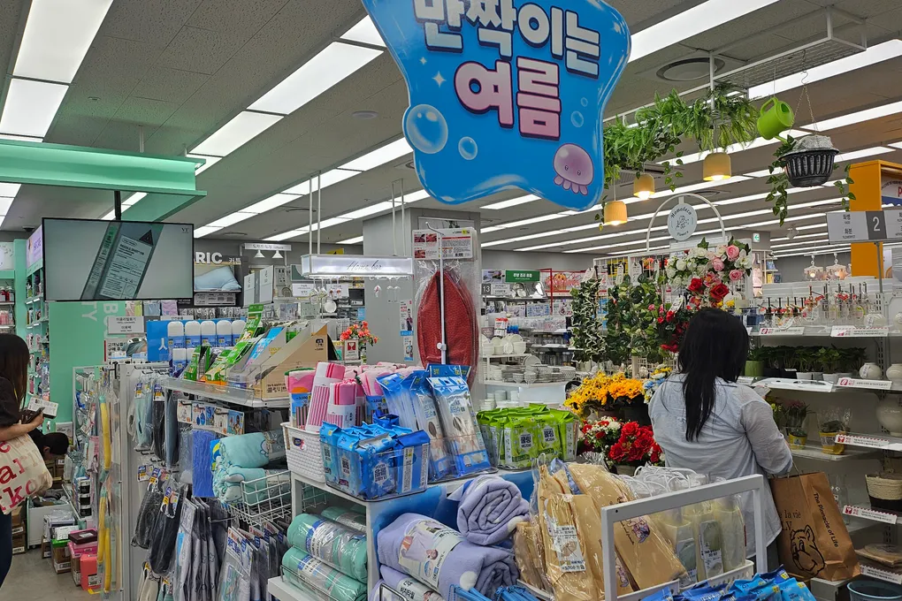 Inside a large Daiso store in Seoul with seasonal summer displays and household goods