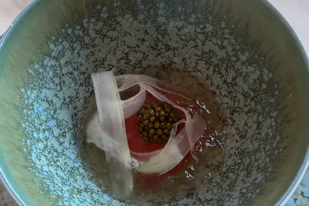 A caviar course at Festa by Choonghu, with caviar over a base wrapped in thin ribbons in a glazed bowl