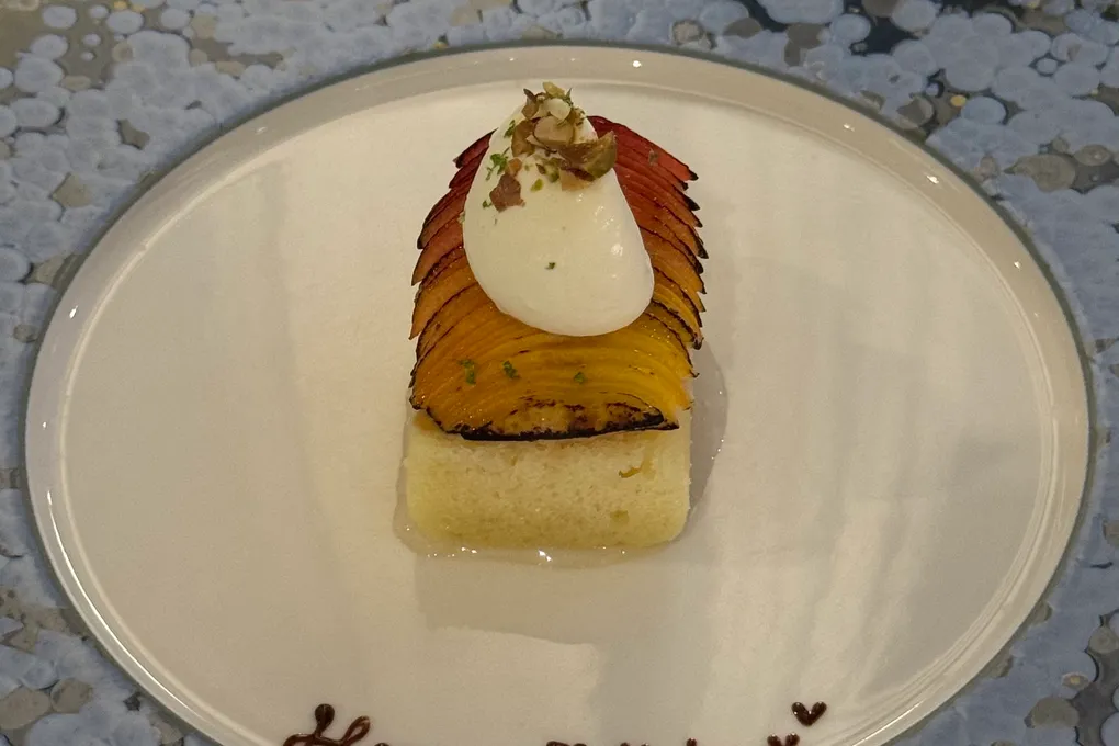 A 'Happy Birthday' dessert plated on a blue speckled plate at Festa by Choonghu