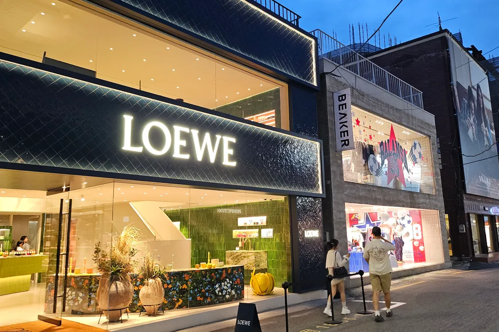 The LOEWE flagship store in Seongsu lit up at night next to the BEAKER concept store