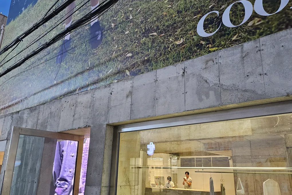 A fashion store in Seongsu with a translucent illuminated facade and clothing displays